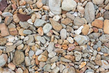 A  stone are small and big size with colourful  at the coastal .