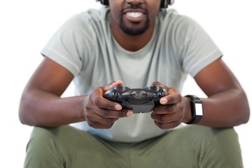 Man playing video game against white background