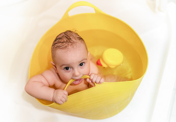Bathing baby nibbles bucket handle