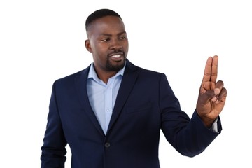 Businessman pressing an invisible virtual screen