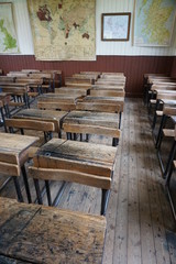 Vintage wooden desks in a well-worn classroom