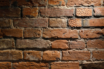 old brickwork of red bricks close-up and at a slight angle. texture and interior design.