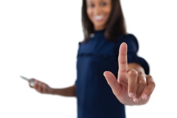 Female executive pressing an invisible virtual screen