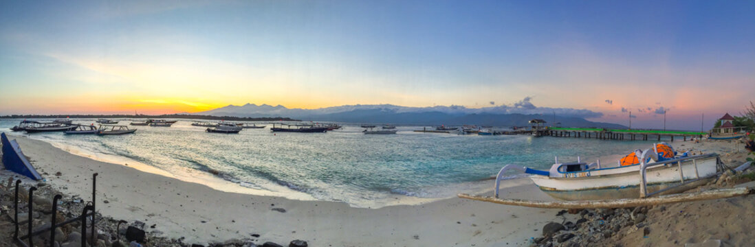 Panorama of Beautiful sunrise with natural colorful sky at Gili Travangan island's port