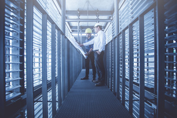 engineer and construction team working on checking progress of construction site;engineer  working on checking progress of construction site