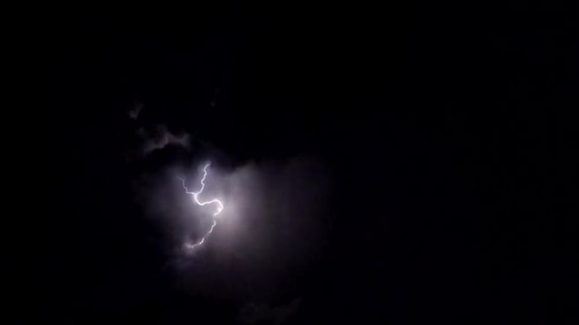 Slow motion, lightning strikes across sky in storm