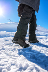Fototapeta na wymiar Winter snow hiking, woman walking on snowy path