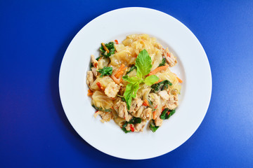 Top view of Stir fried flat noodle and pork with preserved soy bean paste on the white dish