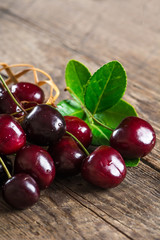 Cherry on a wooden table in a wicker