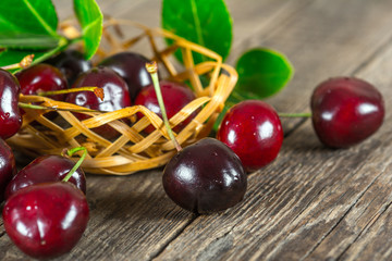 Cherry on a wooden table in a wicker