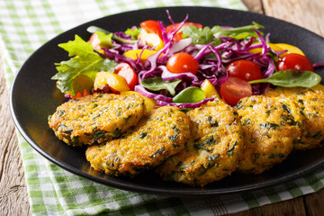 Delicious burgers from quinoa, carrots and spinach and fresh vegetables close-up. horizontal