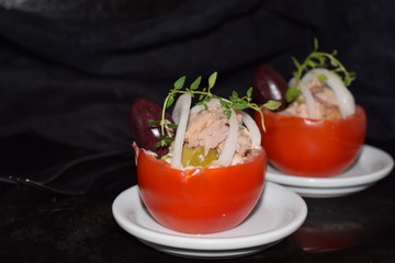 Tomato stuffed with tuna olives and onions.