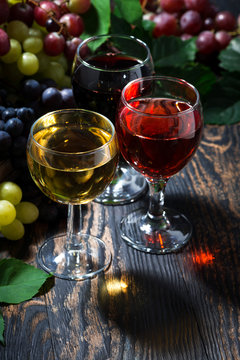 assortment of wine on wooden table, vertical