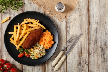 Chicken Kiev (de Volaille chop) with french fries and salads.