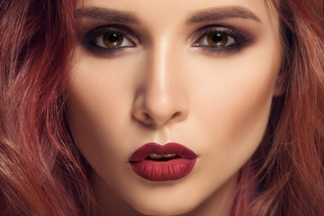 Fototapeta premium Portrait of woman with long curly beautiful ginger hair.