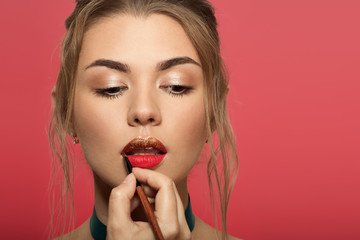 Portrait of beautiful woman with bright make up. Liquid golden lipstick.