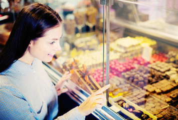 Woman selecting fine chocolates