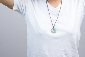 Woman wearing round jade necklace around her neck