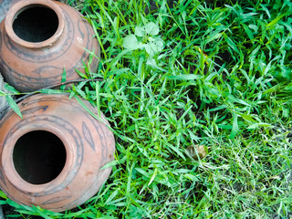 High angle shot of abandoned clay pots on grass