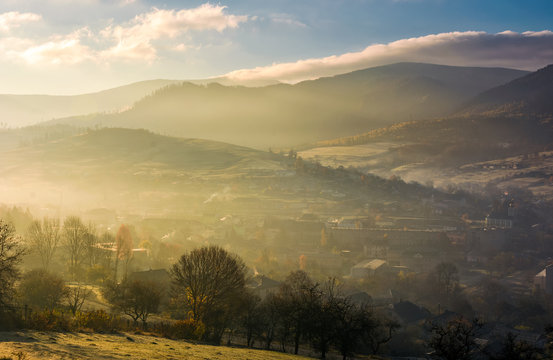 foggy sunrise over the village in valley. gorgeous countryside landscape in autumn