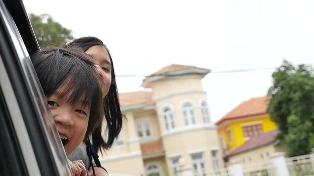 Happy Asian children travels by car, slow motion 