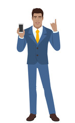 Businessman holding mobile phone and pointing up