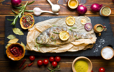Delicious grilled fish on a wooden background