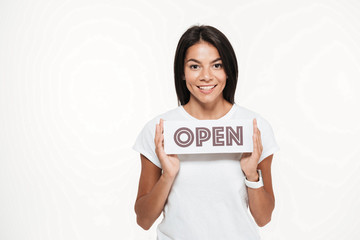 Portrait of a smiling attractive woman showing open sign