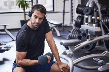 Guy working out with dumbbell in gym