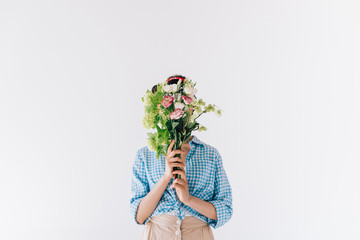 woman covering face with flowers