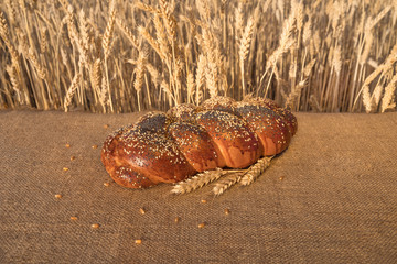 loaf of bread with sesame and poppy lying on table