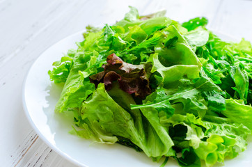 Lettuce salad mix on a wooden table