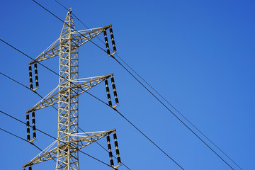 High voltage electric poles on blue sky background   