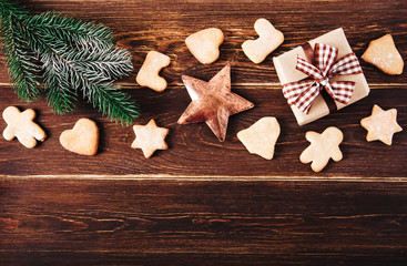 Christmas decoration with gingerbread,gift box,fir,Christmas star.Wooden background.Holiday,new year  concept.Top view.Copy space.