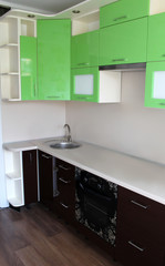 Brown and green kitchen cabinets in the dining room.