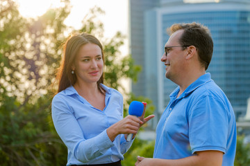 Young girl TV reporter interviews a man