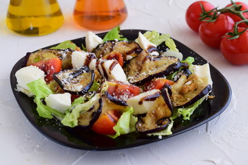Salad with aubergine, tomato, mozzarella, iceberg lettuce