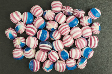 candy in blue, red and white on slate plate