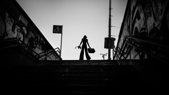 Fototapeta Fashion art portrait of elegant girl in geometric. Black and white photo of stylish young woman in cityscape