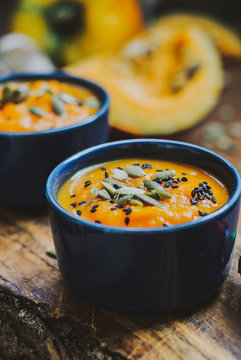 Homemade vegetable soup with pumpkin with cream and black sesame, top view with copy space