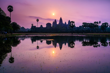 Fototapeta na wymiar Amazing view of Angkor Wat temple at sunrise. The temple complex Angkor Wat in Cambodia is the largest religious monument in the world. Location: Siem Reap, Cambodia. Artistic picture. Beauty world.