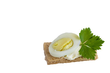 Sandwich with egg, cheese and parsley on a white background .