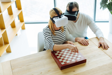 Attractive blonde woman playing virtual chess