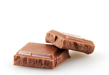 Pieces of chocolate on a white background
