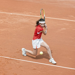Young tennis player in action
