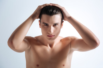 Handsome brunette smoothing his hair