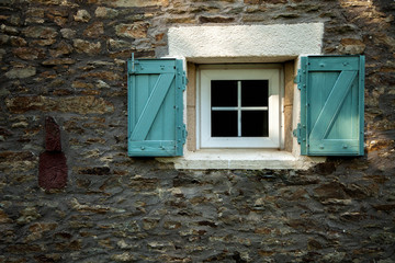 window and shutters on a traditional Breton stone house