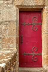 old stone doorway with red wooden door