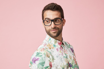 Guy in glasses and shirt, looking over shoulder