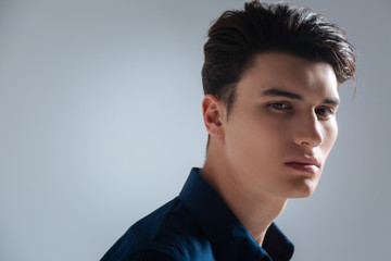 Portrait of serious man that standing over grey background